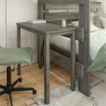 Rustic gray wooden bunk bed with integrated bedside desk, green adjustable stool, book and pencil cup on wood surface, hardwood floor