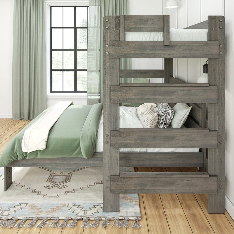 Grey reclaimed wood twin-over-twin bunk bed with sage green bedding and patterned pillows in a sunlit modern farmhouse bedroom with black-framed window, sheer green curtains and decorative area rug