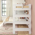 Whitewashed wood bunk bed in a cozy neutral bedroom with sheer curtains, large window, layered bedding and bedside lamp