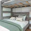 Grey reclaimed wood twin-over-full bunk bed with slatted mattress support, mint green bedding and decorative pillows in a modern farmhouse bedroom