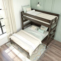 Wooden twin-over-full bunk bed with neutral bedding, decorative pillows and sheer curtains against a mint-green paneled wall — space-saving kids' bedroom design