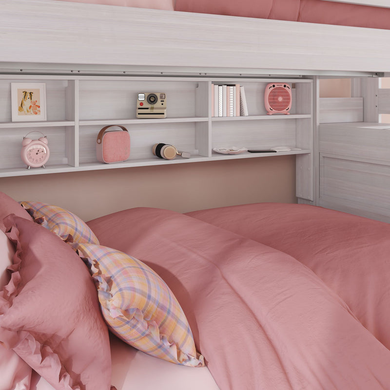 Cozy pink bedroom with soft pink duvet and plaid pillows under a white loft bed with built-in shelves displaying a pink alarm clock, retro camera, headphones and books