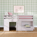 Whitewashed kids loft bed with pink bedding, green gingham wallpaper and framed bicycle wall art over shelf with books and jute rug.