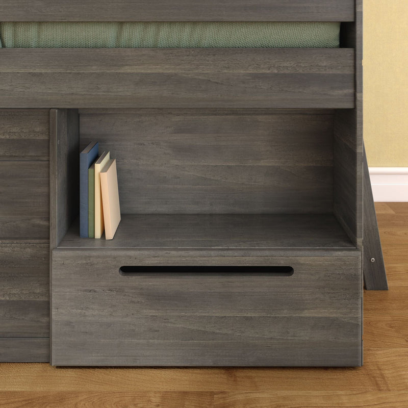 Modern gray wood bunk bed with built-in shelf and pull-out drawer, stacked books on shelf, green mattress edge and hardwood floor