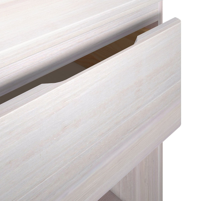 Close-up of a whitewashed wood drawer with integrated finger-pull handle and light wood grain finish for a modern nightstand