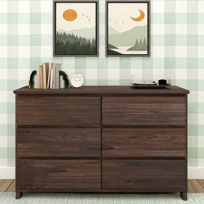 Modern farmhouse wooden dresser with green plaid wallpaper, framed minimalist landscape prints, agate bookends holding books, white alarm clock and record player