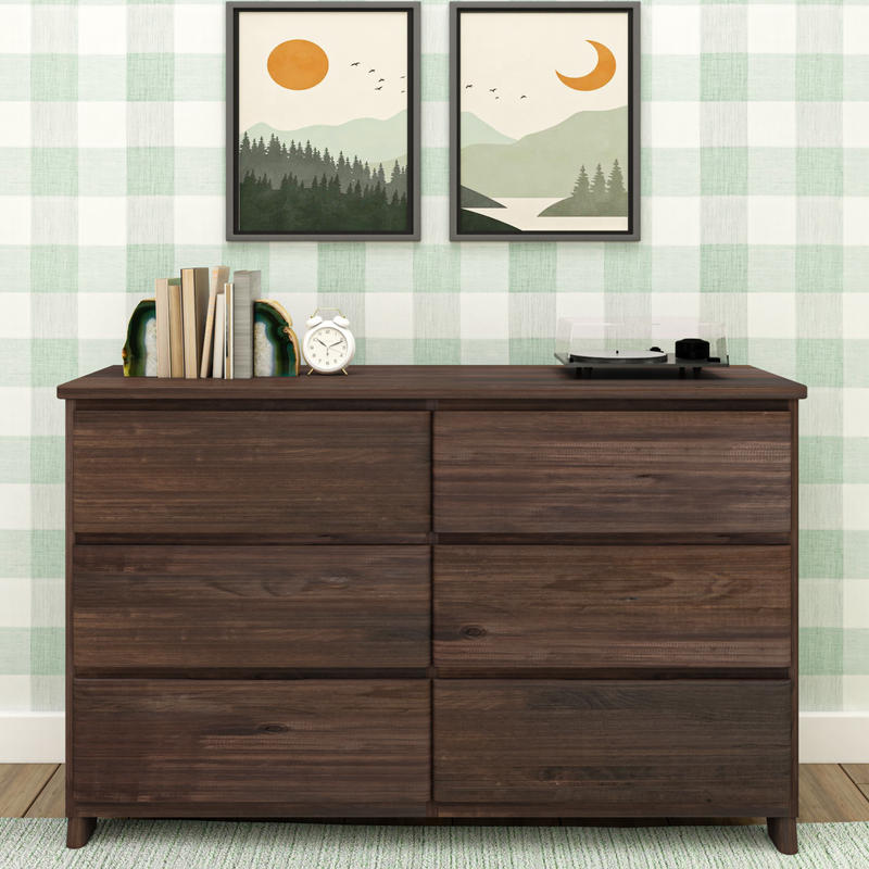 Modern farmhouse wooden dresser with green plaid wallpaper, framed minimalist landscape prints, agate bookends holding books, white alarm clock and record player