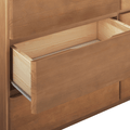 Partially open light natural wood dresser drawer with visible metal slides, close-up bedroom storage detail