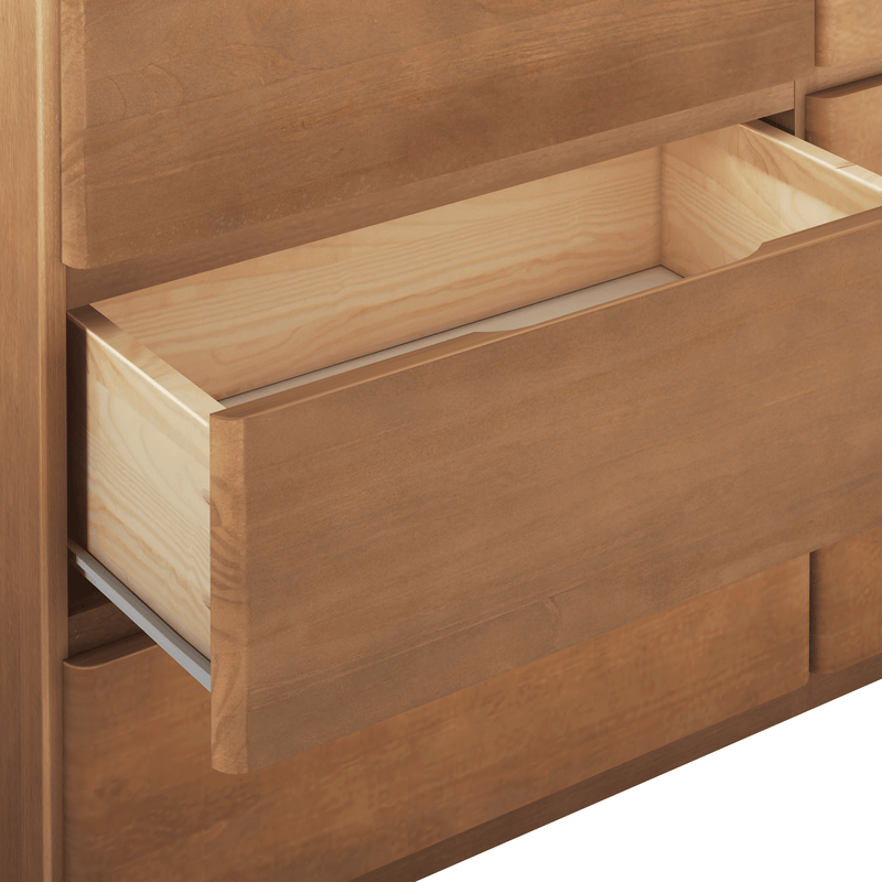Partially open light natural wood dresser drawer with visible metal slides, close-up bedroom storage detail