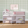 Children's pastel bedroom with white bunk bed, pink bedding, green gingham wallpaper, framed bicycle wall art and toy storage