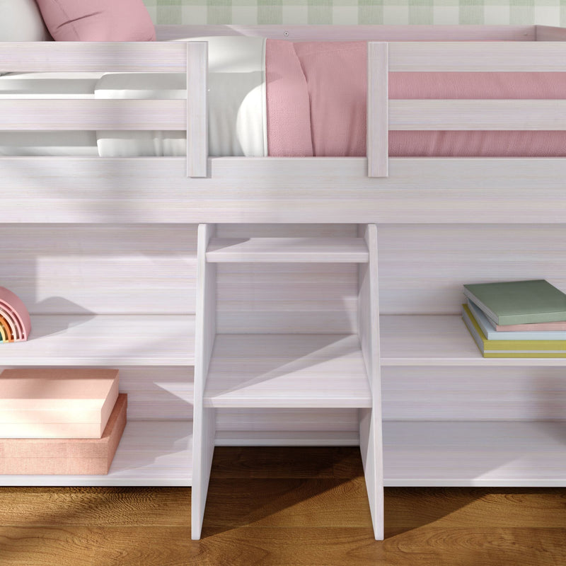 White wooden kids loft bed with built-in ladder, pink bedding and storage cubbies on hardwood floor in a modern children's bedroom