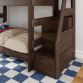 Dark walnut wooden bunk bed with built-in storage stairs and drawers, beige bedding with blue race car pillow on lower twin, navy blue checkered rug