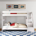 White wooden bunk bed with stairs and storage in kids' room, car-themed bedding, framed vintage car prints and blue checkered rug