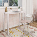 Modern pastel pink girls' bedroom study nook with white wooden desk, gold geometric table lamp, clear acrylic swivel chair, open notebook, pencil holder, potted plant and patterned rug