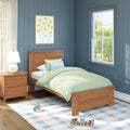 Kids bedroom with wooden twin bed, pastel green bedding, blue paneled walls, bedside lamp, framed yellow flower art, sunny window and toys on rug