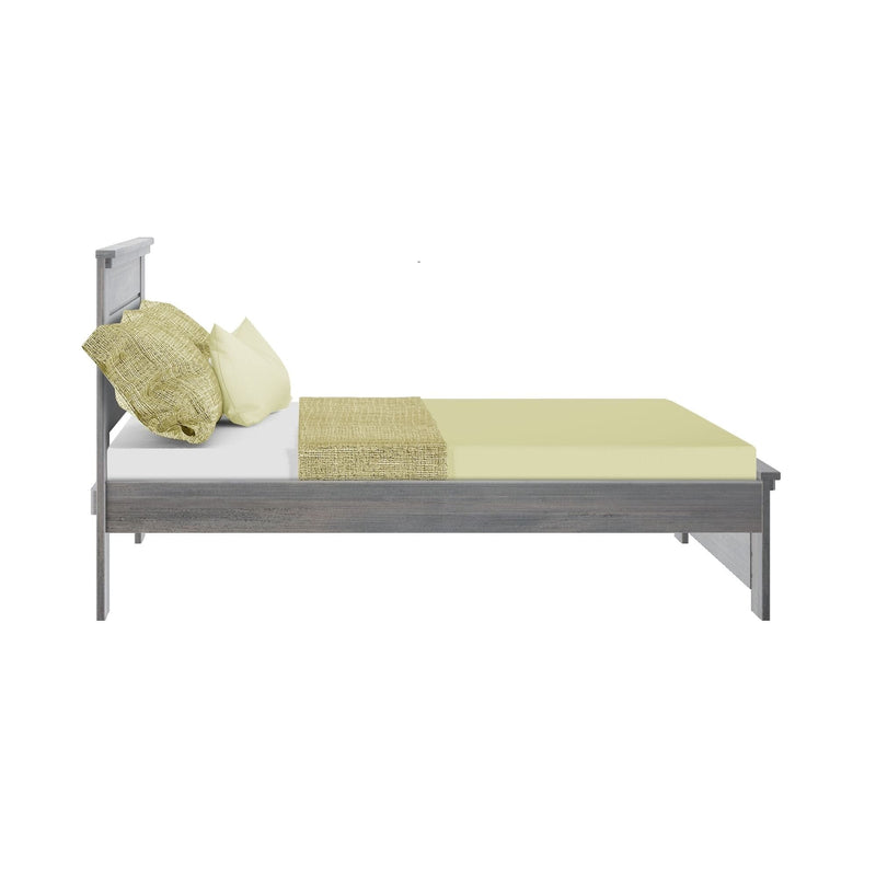 Side view of modern gray wooden bed frame with light green linens, textured throw blanket and pillows on a white background