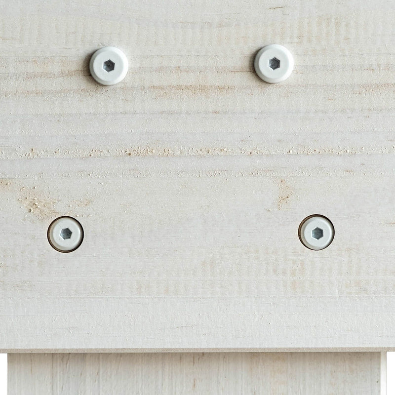 Close-up of light pine wood panel with four recessed white hex-socket screws, countersunk furniture assembly and woodworking detail