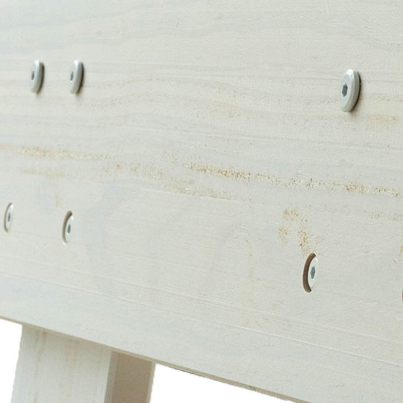Close-up of light wood furniture assembly showing recessed hex screws and white washers on a whitewashed wood plank