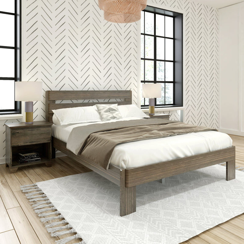 Modern bedroom with wooden platform bed, neutral taupe bedding, herringbone patterned wallpaper, black-framed windows, bedside lamps and woven pendant light
