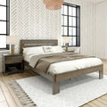 Minimalist modern bedroom interior with wooden platform bed, neutral bedding, patterned chevron wallpaper, black-framed windows, bedside lamps and textured area rug