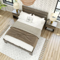 Modern neutral bedroom with wooden platform bed, white linens and beige throw, matching nightstands and lamps on hardwood floors with textured area rug