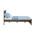 Side view of dark wood platform bed with light blue mattress, textured blue and white pillows and matching throw for modern bedroom