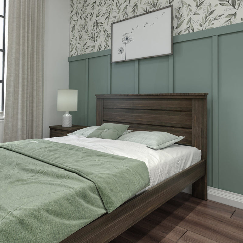Modern bedroom with sage green bedding, dark wood bed frame, nightstand lamp, teal board-and-batten and botanical wallpaper