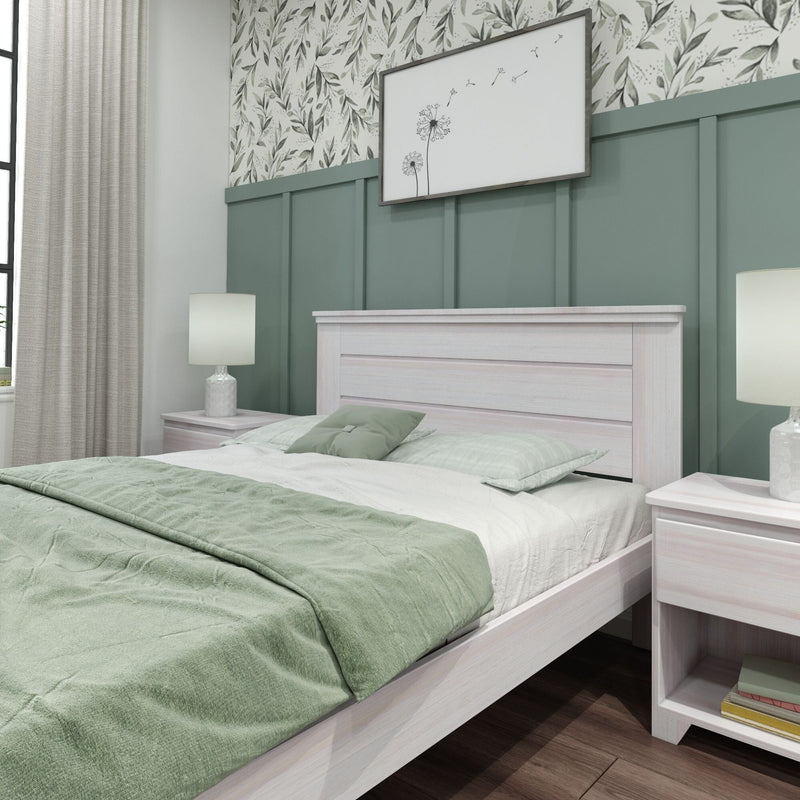 Modern bedroom with light wood bed, mint green bedding, board-and-batten sage accent wall, botanical wallpaper and bedside lamps