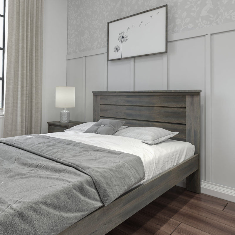 Modern farmhouse bedroom with dark wooden platform bed, gray bedding, paneled accent wall, minimalist dandelion wall art, neutral curtains and bedside lamp