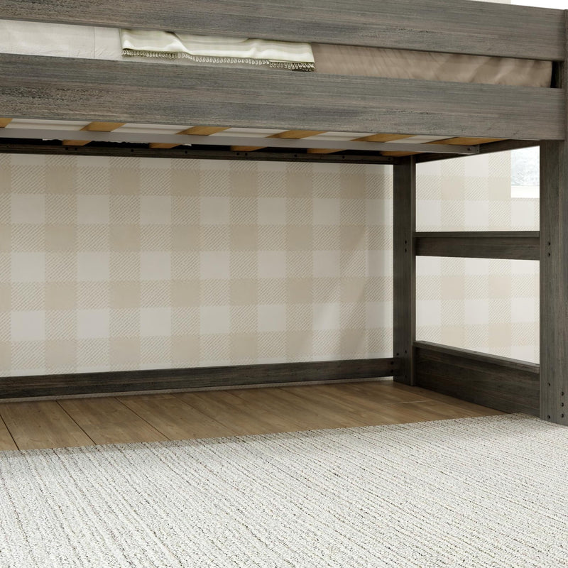Gray weathered wood loft bed frame with ladder and slatted mattress platform above hardwood floor and neutral plaid wallpaper in children's bedroom
