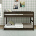 Dark wooden bunk bed in a cozy kids bedroom with pale green gingham wallpaper, neutral bedding and framed nature prints