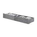 Gray wood under-bed storage drawers with pull-out twin trundle compartments containing pillows and folded blankets — space-saving bedroom storage solution