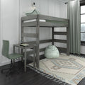 Grey wood loft bed with built-in desk, mint green bedding and bean bag chair, patterned area rug and curtains in a modern kids' bedroom workspace