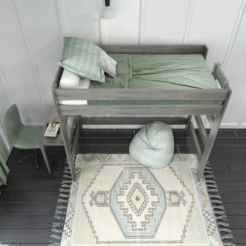 Wooden loft bed with mint green bedding, built-in desk and chair over patterned boho rug in modern kids' bedroom