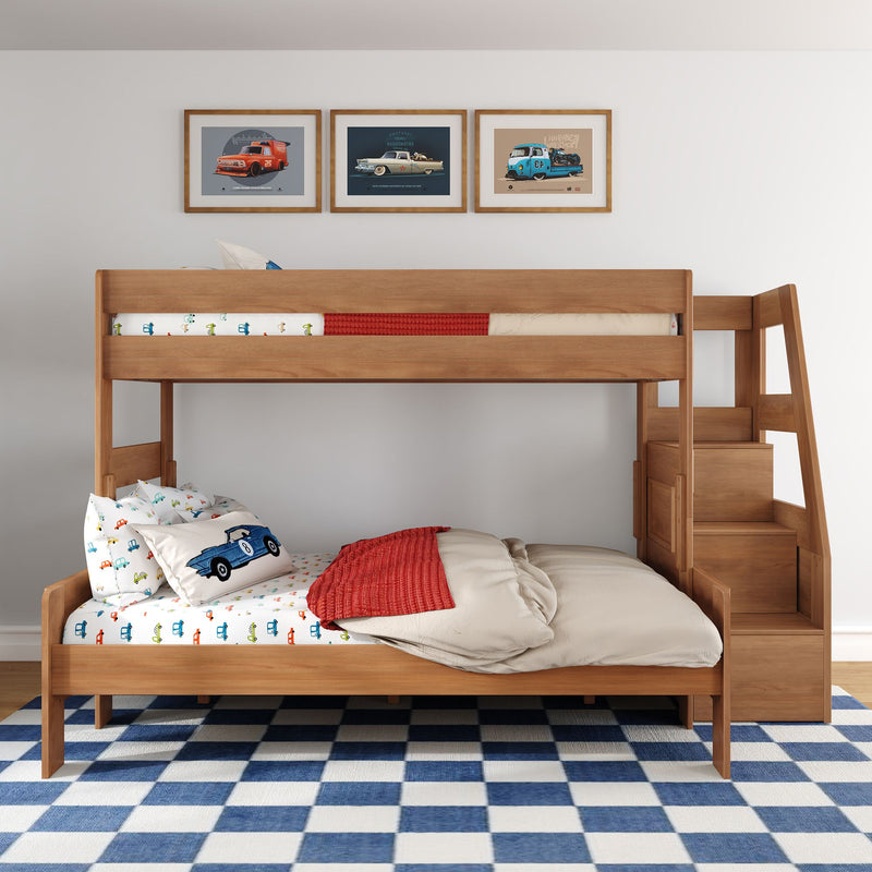 Wooden kids bunk bed with built-in stairs and storage, car-themed bedding and pillows, red throw blanket, vintage car wall art and blue check rug
