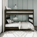 Dark wood bunk bed with white linens and pillows, wall sconces and pale blue paneled wall over patterned rug in modern bedroom