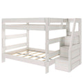Whitewashed wooden twin-over-full bunk bed frame with safety rails, slatted mattress supports and staircase with built-in storage drawers