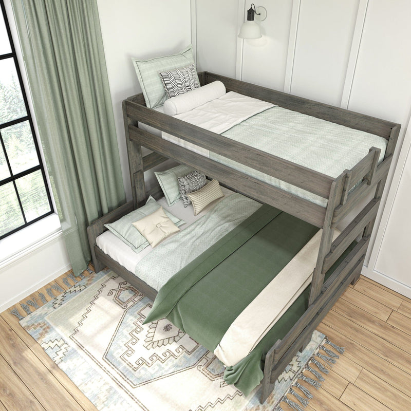 Rustic gray wooden bunk bed with sage green bedding, patterned throw pillows and rug in a bright modern farmhouse bedroom next to a large window and wall sconce