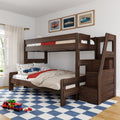 Dark wood kids bunk bed in children's bedroom with car-themed bedding and toy cars, framed vintage car prints, blue checkered rug and staircase storage