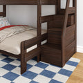 Dark walnut wood bunk bed with built-in staircase storage drawers, beige bedding and car-print pillow on blue checkered rug — space-saving kids bedroom furniture