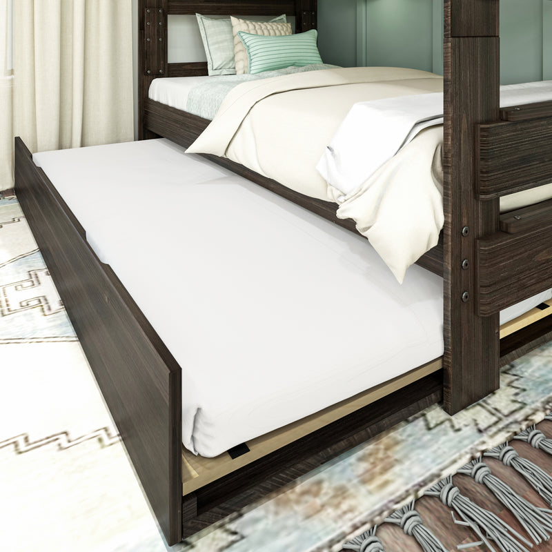 Modern dark wood bunk bed with pull-out trundle, white mattress and beige duvet styled with mint green pillows on patterned rug