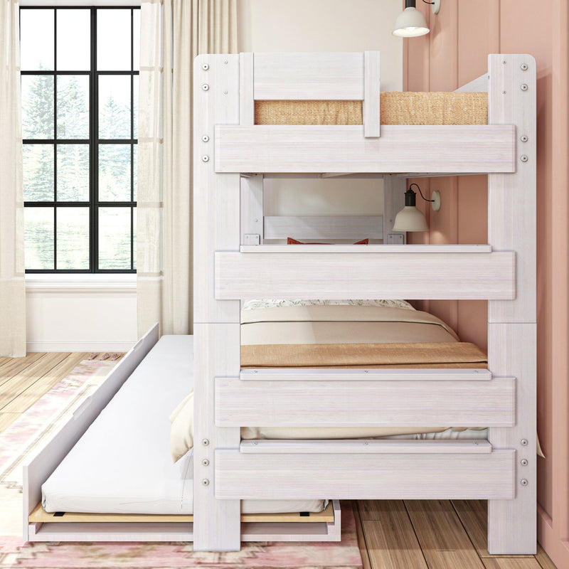 Whitewashed wooden bunk bed with pull-out trundle in a sunlit kids' bedroom, beige bedding, wall-mounted lamp and black-framed window