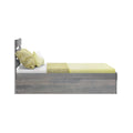 Twin gray wood platform bed with modern headboard, yellow sheets and textured pillows, side view on white background