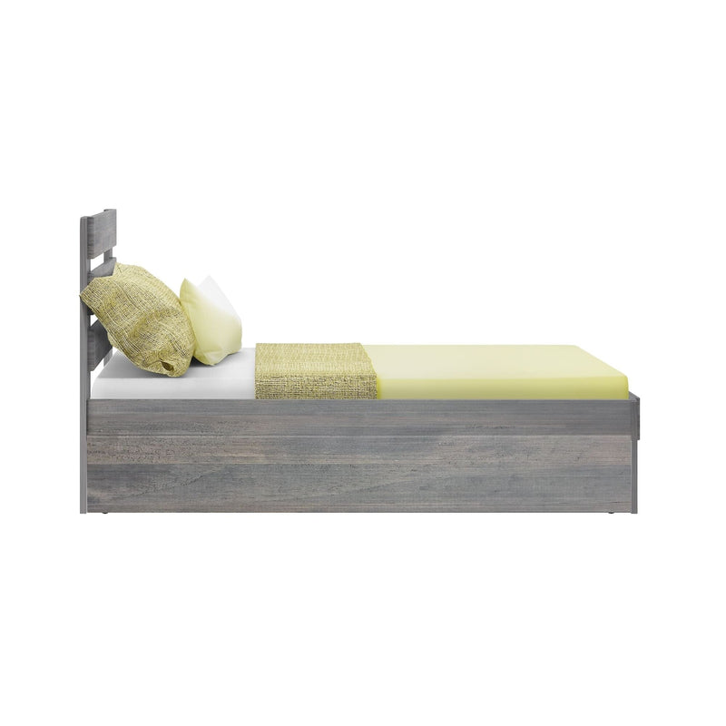 Twin gray wood platform bed with modern headboard, yellow sheets and textured pillows, side view on white background