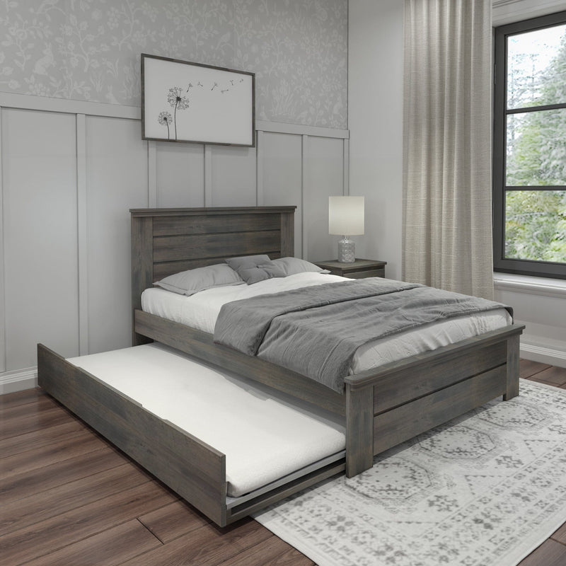 Gray wooden platform bed with pull-out trundle, neutral bedding, nightstand lamp and dandelion wall art in modern farmhouse bedroom with linen curtains and hardwood floors