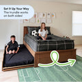 Pull-out trundle bed for kids in bright bedroom — wooden platform bed with gray plaid bedding, soccer plush, green soccer rug and wall art
