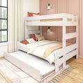 Modern white wooden bunk bed with pull-out trundle in kids' bedroom, coral accent pillows, neutral bedding and wall-mounted reading lights against pink paneled wall