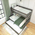 Rustic wooden twin bunk bed with green bedding and patterned pillows, light-green curtains and hardwood floor in modern farmhouse kids' bedroom
