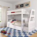 White wooden bunk bed with ladder and under-drawer storage in a children's bedroom, car-themed bedding and framed vintage car prints, blue checkered rug and toy car carrier on hardwood floor