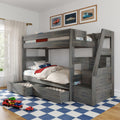 Gray wooden bunk bed with built‑in storage drawers and trundle bed in a children's bedroom with car-themed bedding, framed car prints, blue checkered rug and toy cars